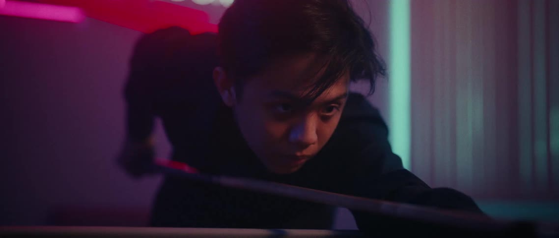 Concentrated person playing pool in a lowlight environment