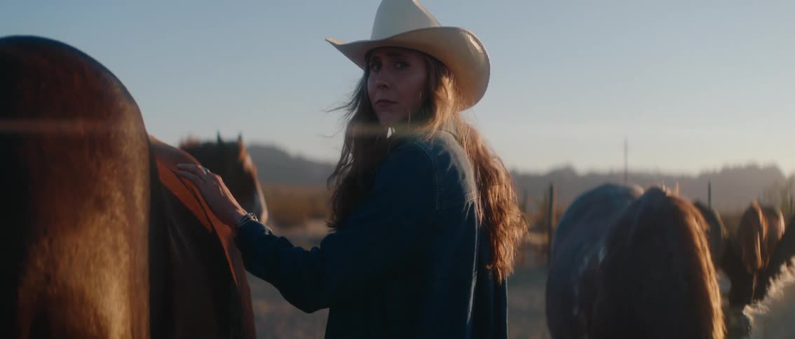 A woman is petting her horses