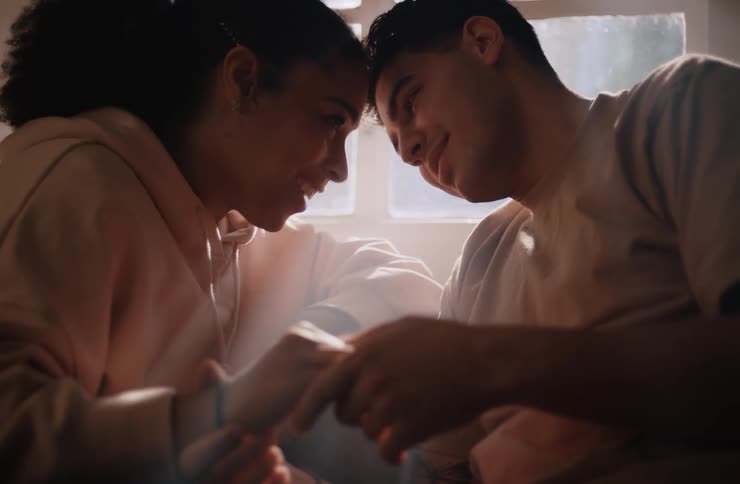 Couple holding hands kissing