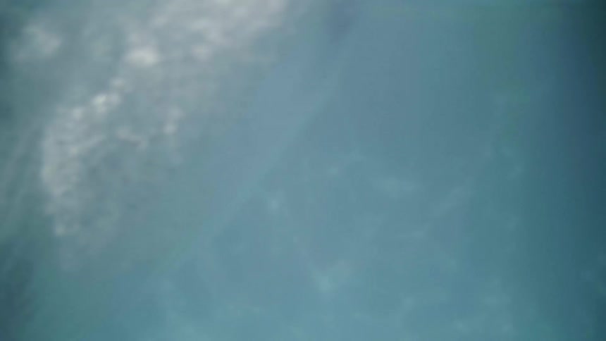 A person jumps into a swimming pool