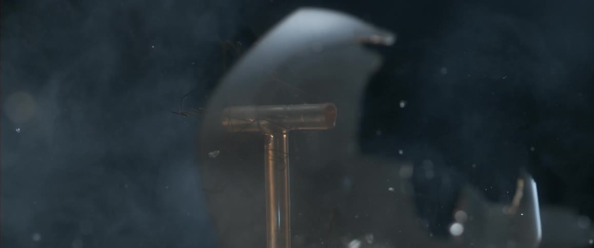 A light bulb being shattered in a dark area