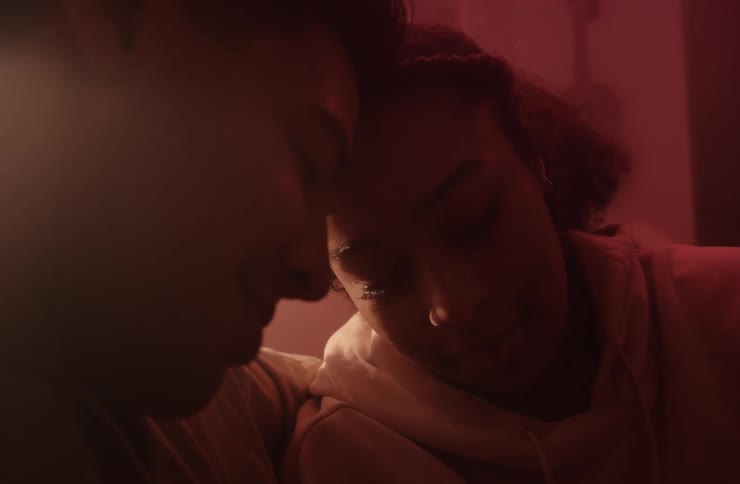 Couple sitting indoors with their heads touching each other
