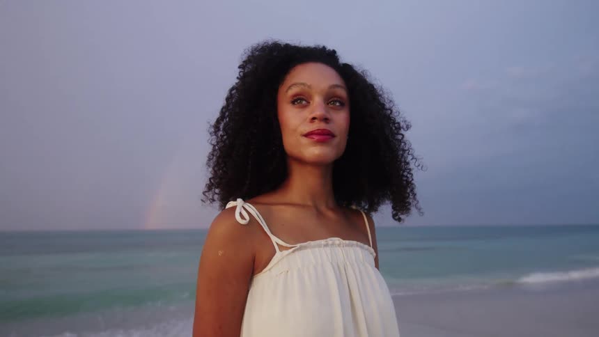 Woman in white dress on the beach