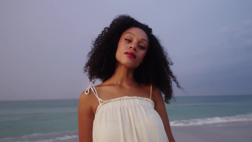 Woman with curly hair on the beach