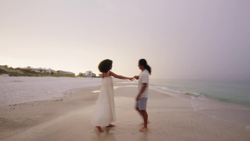 Couple on a deserted beach hugging each other