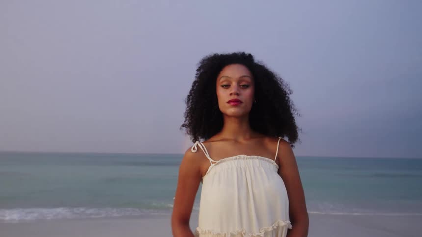 A woman walks up on the beach