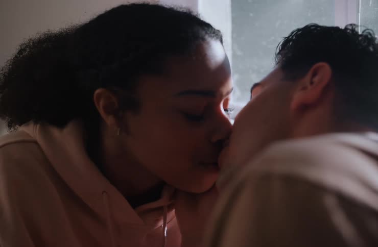 Couple in an indoor space kissing