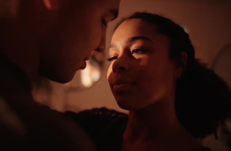 Woman and a man in an indoor space in a romantic moment