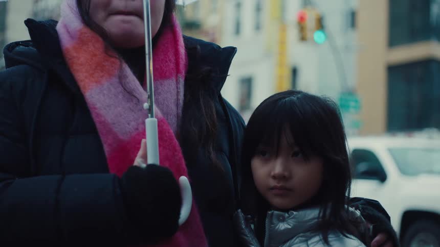 Mother and daughter hugging under an umbrella
