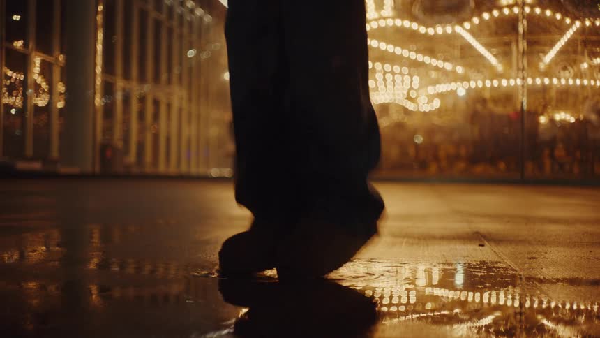 A person jumps up and down on the puddle of water
