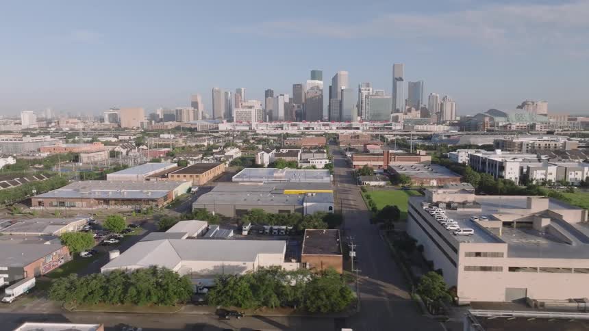 Aerial view of city with skyscrapers and industrial buildings