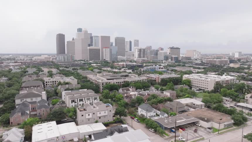 A city skyline view revealing a series of highrises and skyscrapers at midday