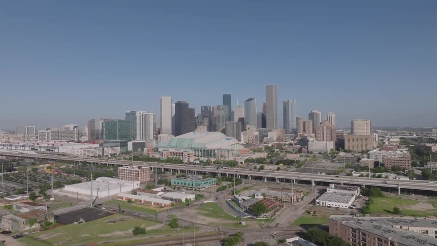 Aerial panorama of a modern metropolis with overpasses and vehicle traffic during the day
