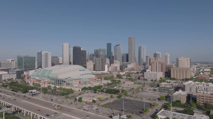 Aerial aerial scene of an overpass with vehicle traffic and skyscrapers of a city in the background