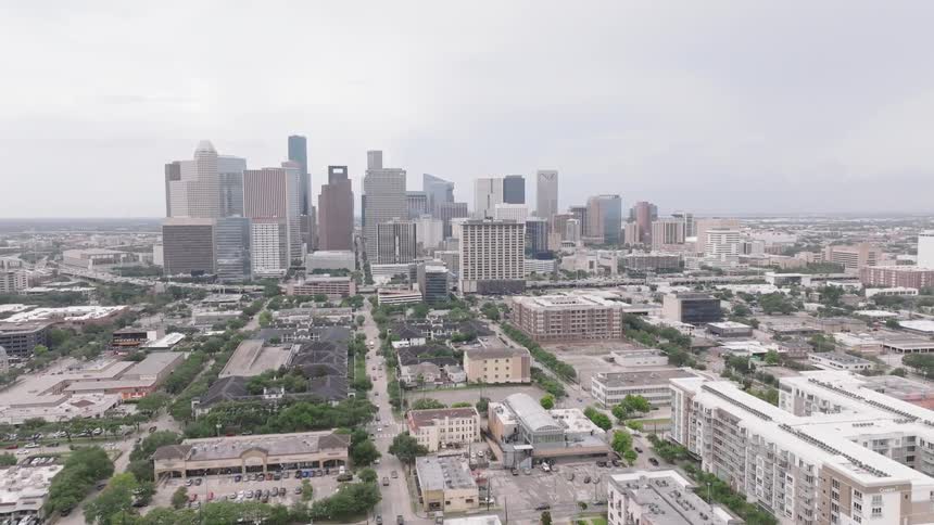 Aerial of a suburban and metropolitan city skyline during daytime