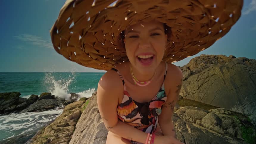 The woman laughs on the beach