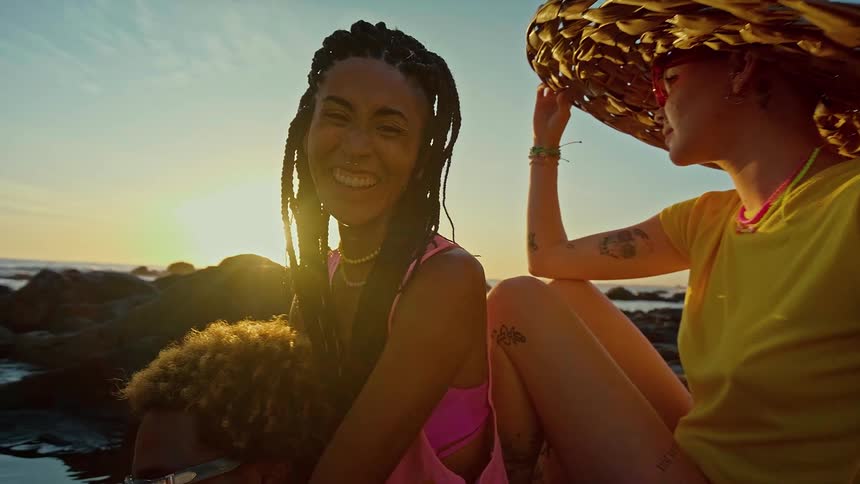 Three people having fun in a beach setting in the late afternoon