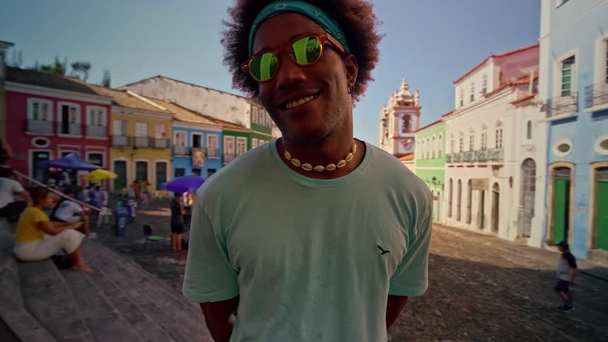 Smiling man with mirrored sunglasses on a colorful colonial street