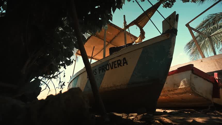 Wooden boat moored on the beach sand