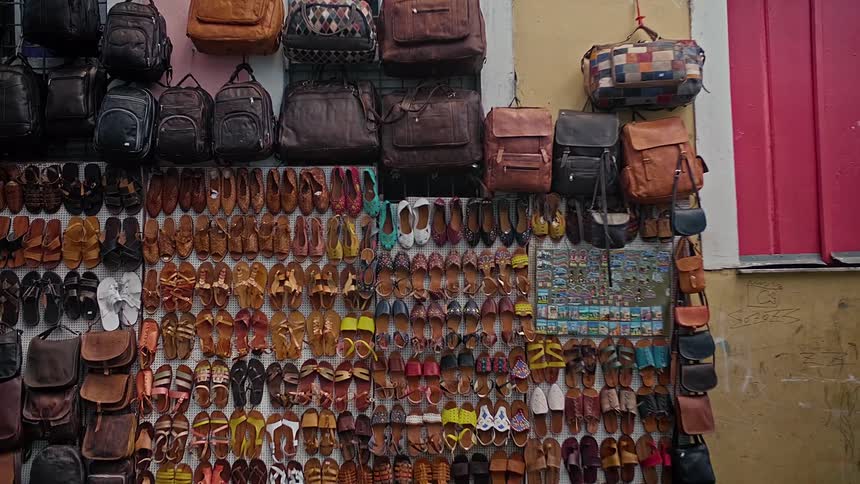 Wall with backpacks and sandals for sale