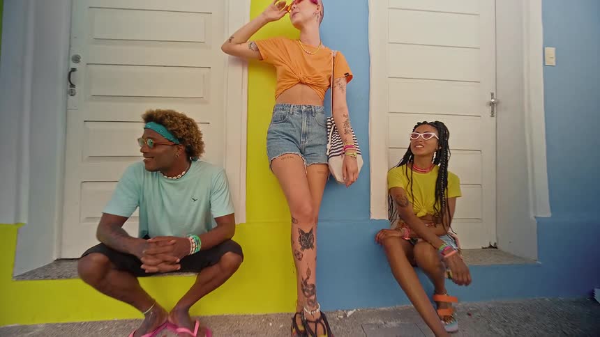 Three people leaning against each other in a classic urban area