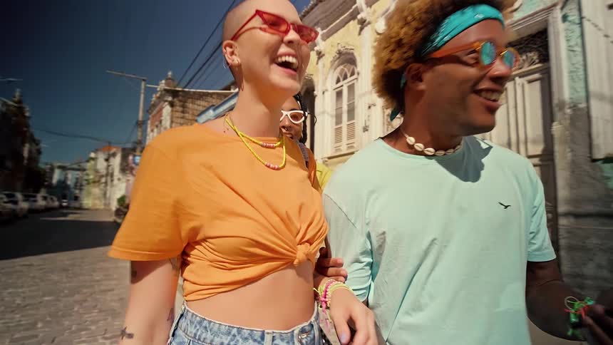 Cheerful friends walking in an urban neighborhood during the day