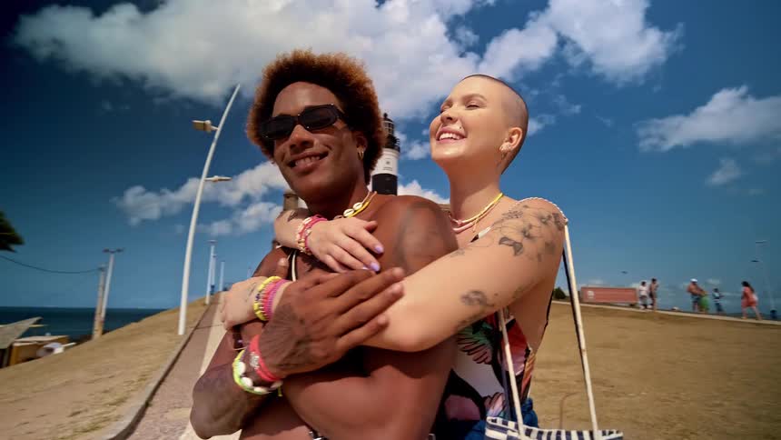 Woman hugging another man in a tourist and beach environment