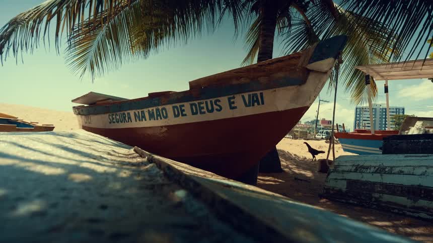 Wooden boats moored on the beach sand