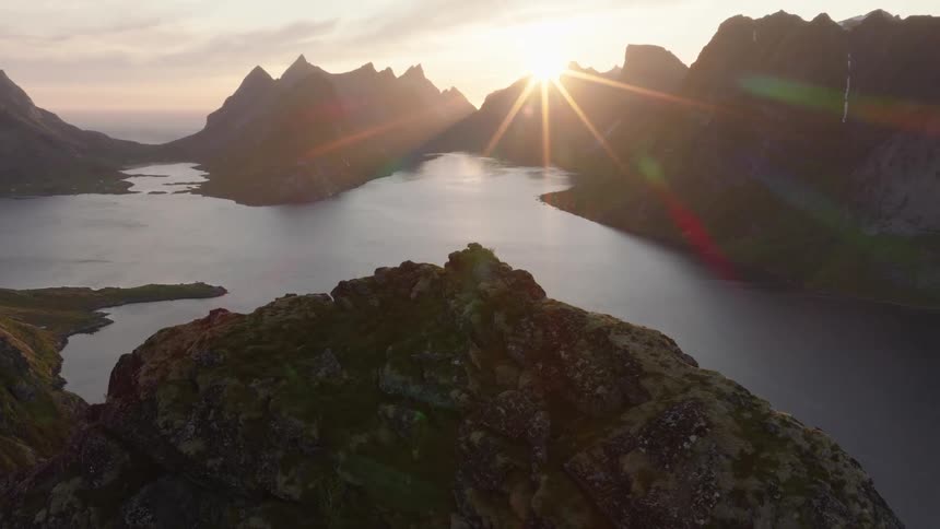 Aerial view of mountains in the middle of the sea at dawn