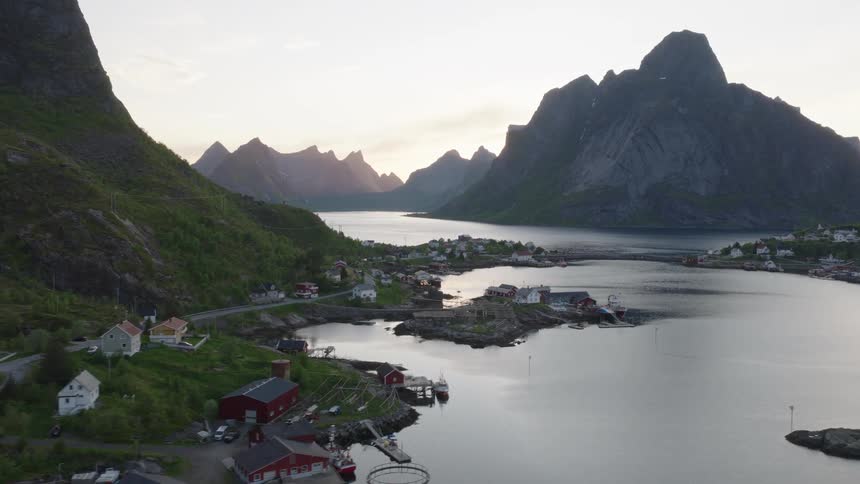 Coastal village surrounded by mountains next to a fjord