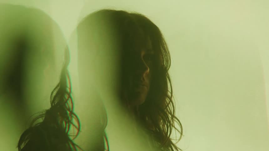 Woman in an interior space with colored lights