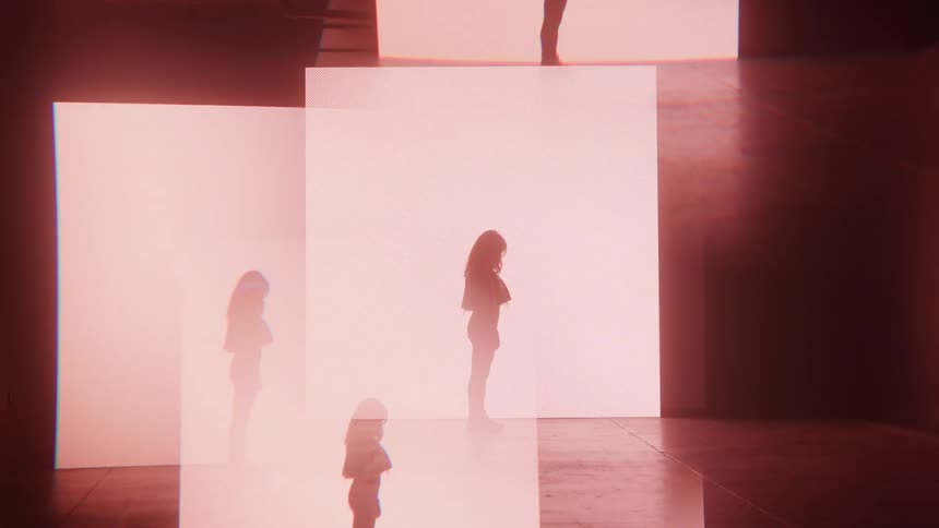 A woman standing on a stage as lights continue to flicker