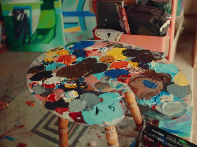 Colors on pallet and there are some artist tools nearby