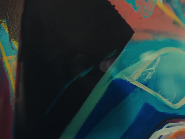 Closeup of two artistic paintings with colorful abstract paints