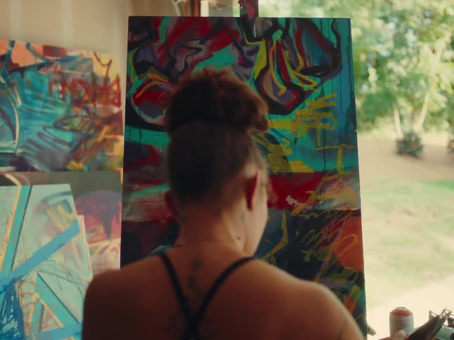 Woman in front of a screen preparing objects