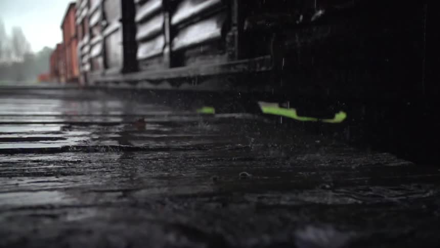 Rain pouring down by some train carts