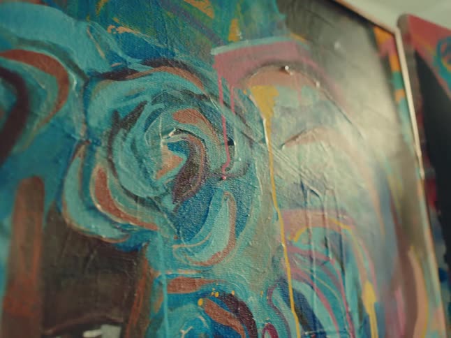 Close up of art paintings on canvases in a room during daytime