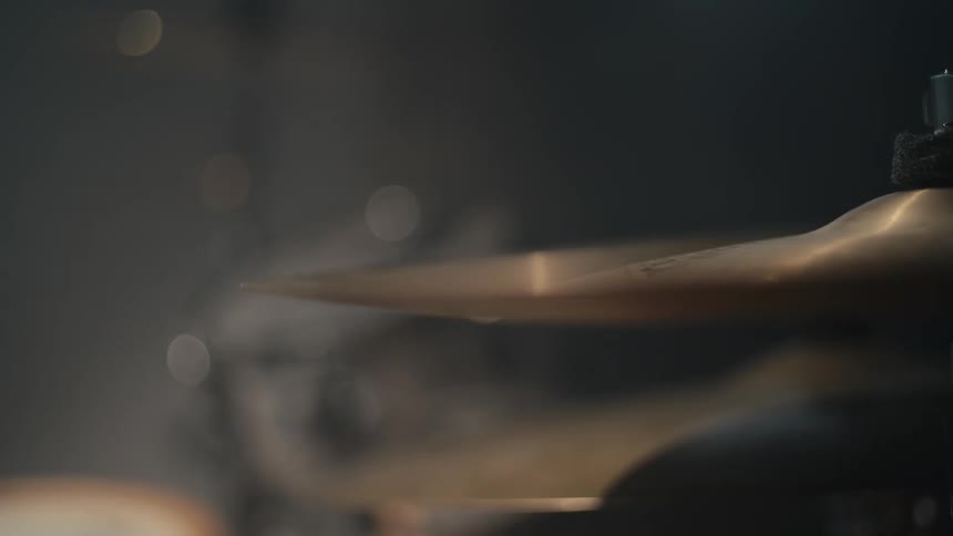 The video shows a closeup of a drummer playing the hihat cymbal a drumstick quickly hits the cymbal creating a blur of motion