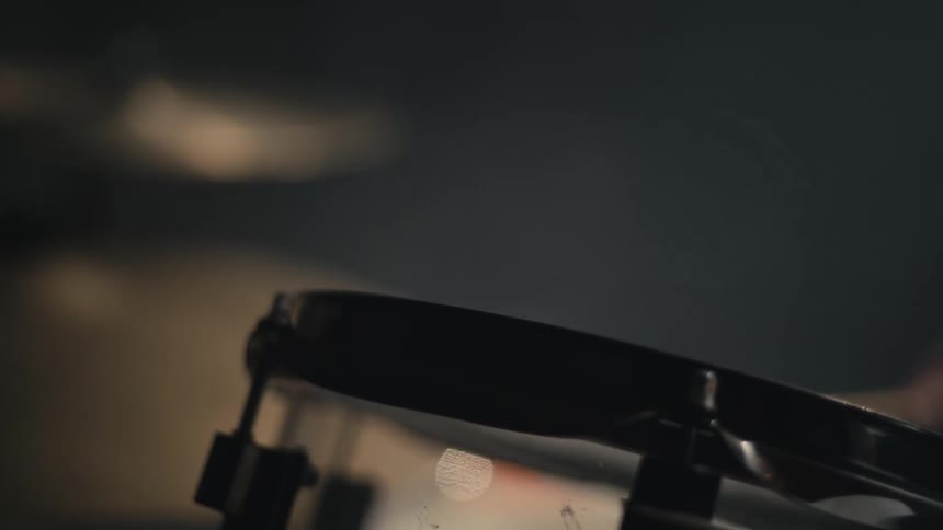A drummer playing and beating the drum