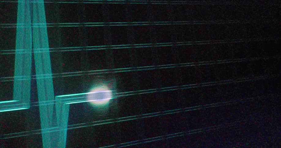 A green line on a dark grid moves across the screen forming a wave a bright white light follows the line as it moves creating a pulse effect