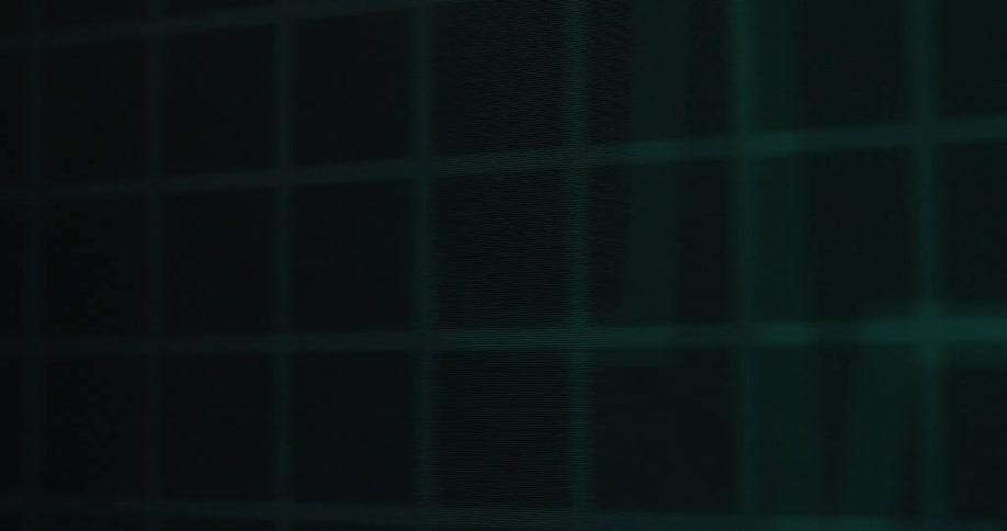 A green waveform with a bright pulsing light moves across a dark screen with a grid pattern briefly disappearing and then reappearing