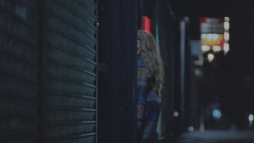 A man and woman run into the building