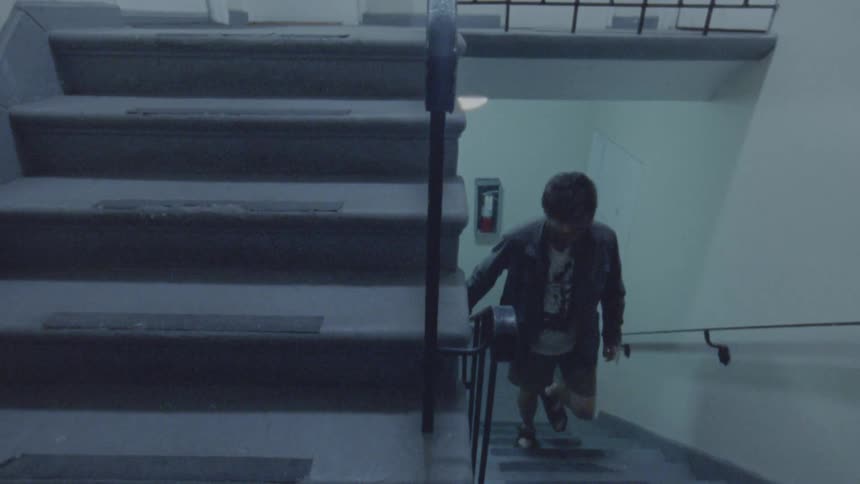 The man is climbing up the staircase