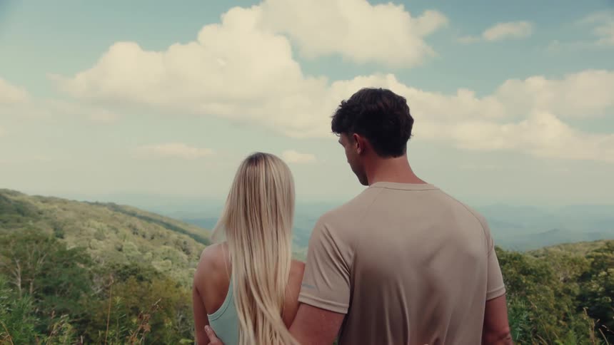 Couple together enjoying a wooded mountain landscape