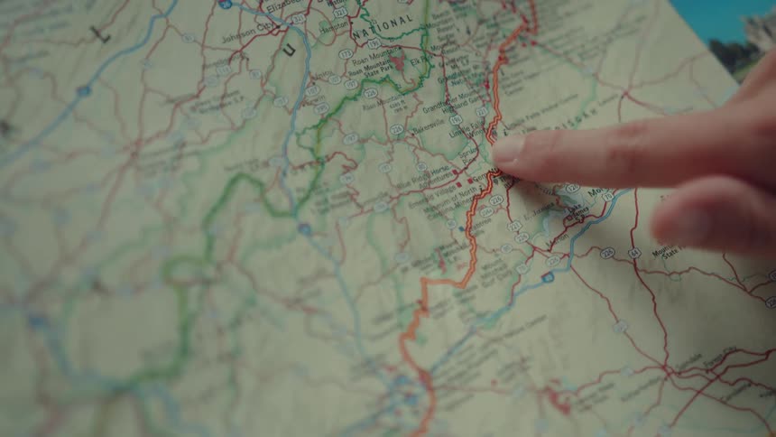 Womans finger pointing to a route on a map