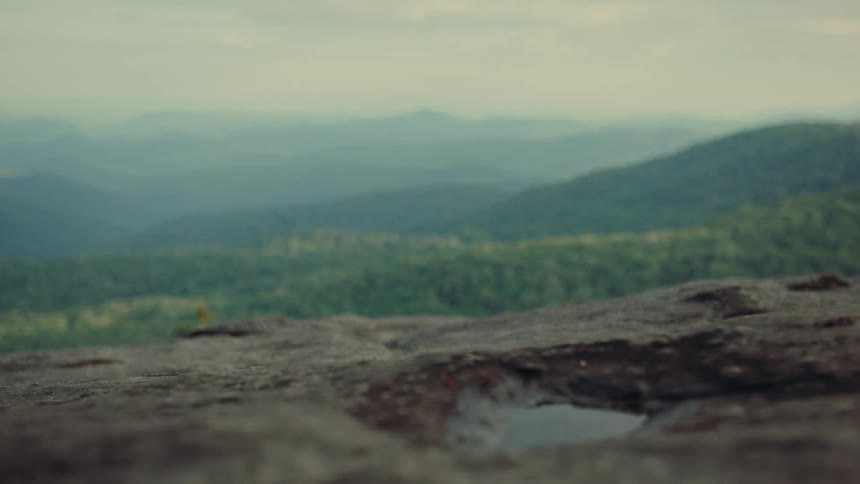Vast mountain landscape under a hazy sky