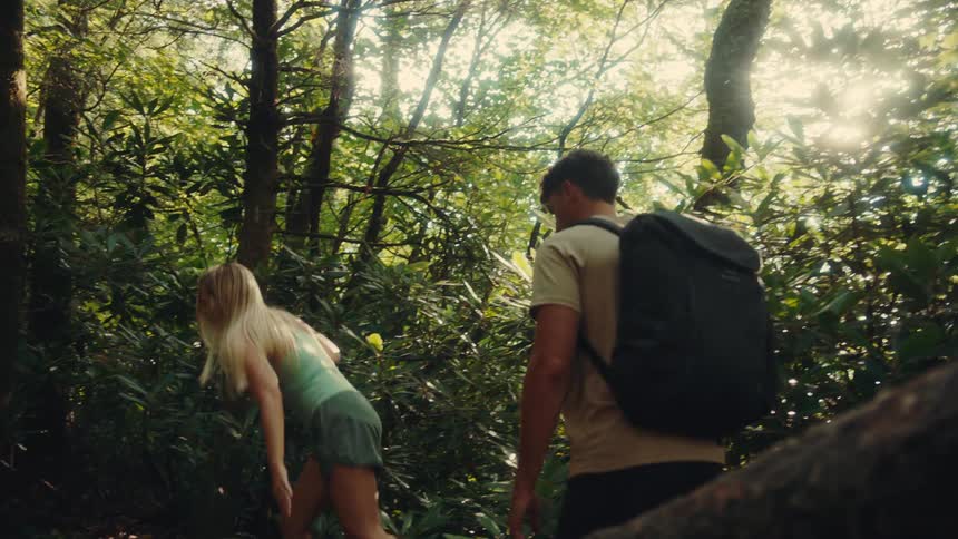 Men and a woman hiking in the forest