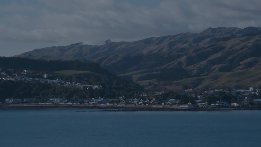 Picturesque town on the seashore with mountains in the background