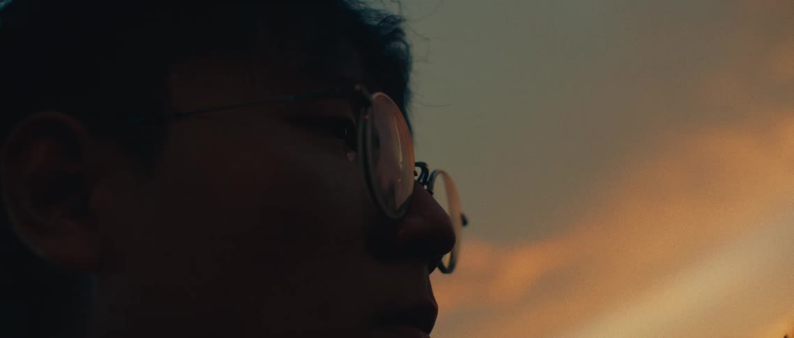 Man wearing glasses in an outdoor setting in the late afternoon