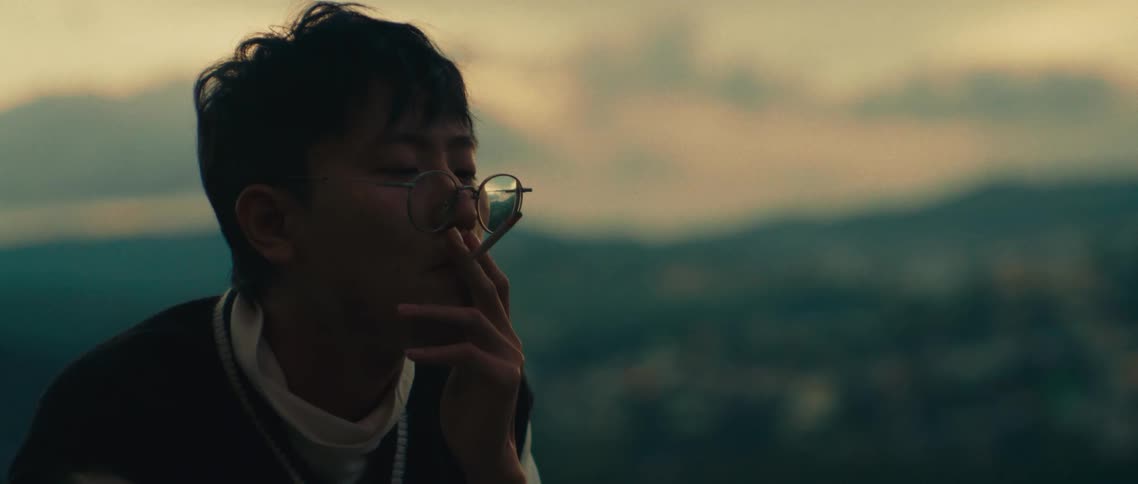 A man is smoking a cigarette outside